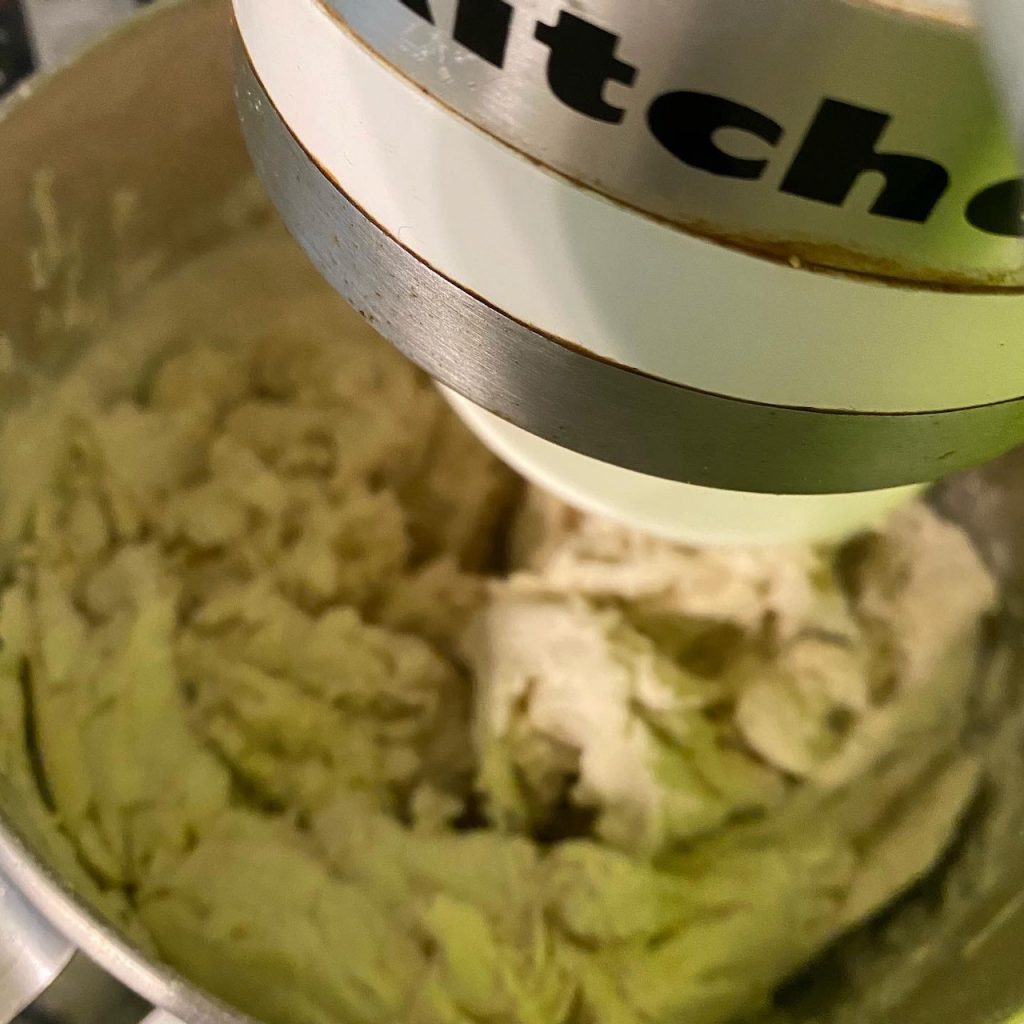 The inside of a mixing bowl full of shaggy bread dough.