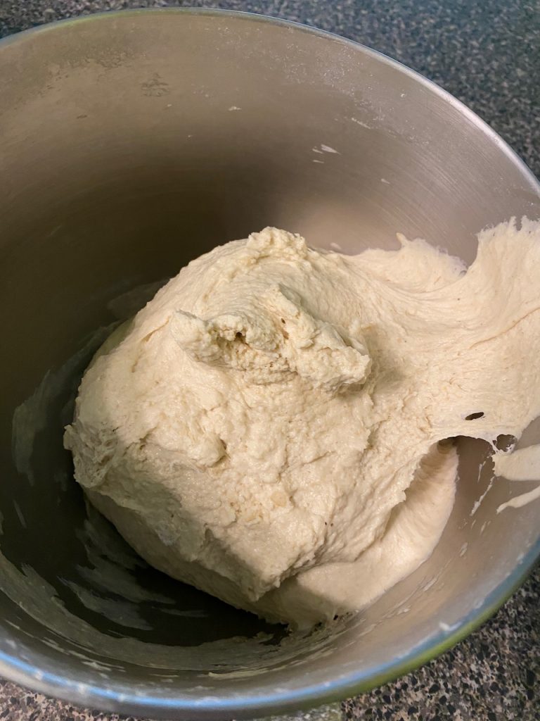 A shaggy mess of kneaded dough in the mixing bowl.