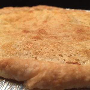 A close up of the incredible crust on top of the filling of the pie.