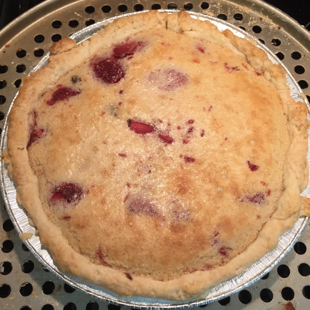 A finished chocolate covered strawberry chess pie.