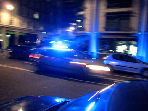 a police car races down the street