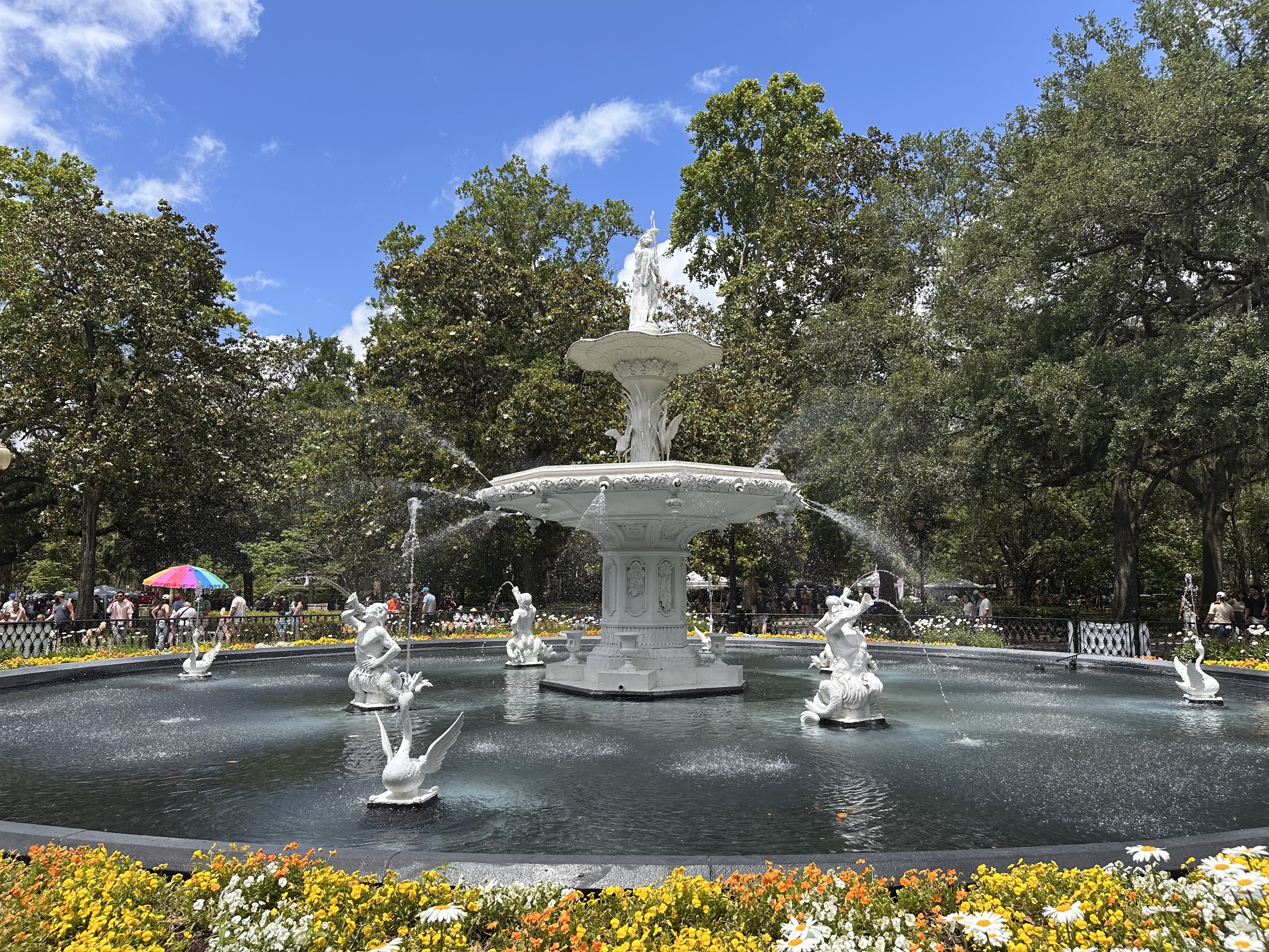 The Forsyth Park fountain surrounded by flowers on a sunny day in May. 