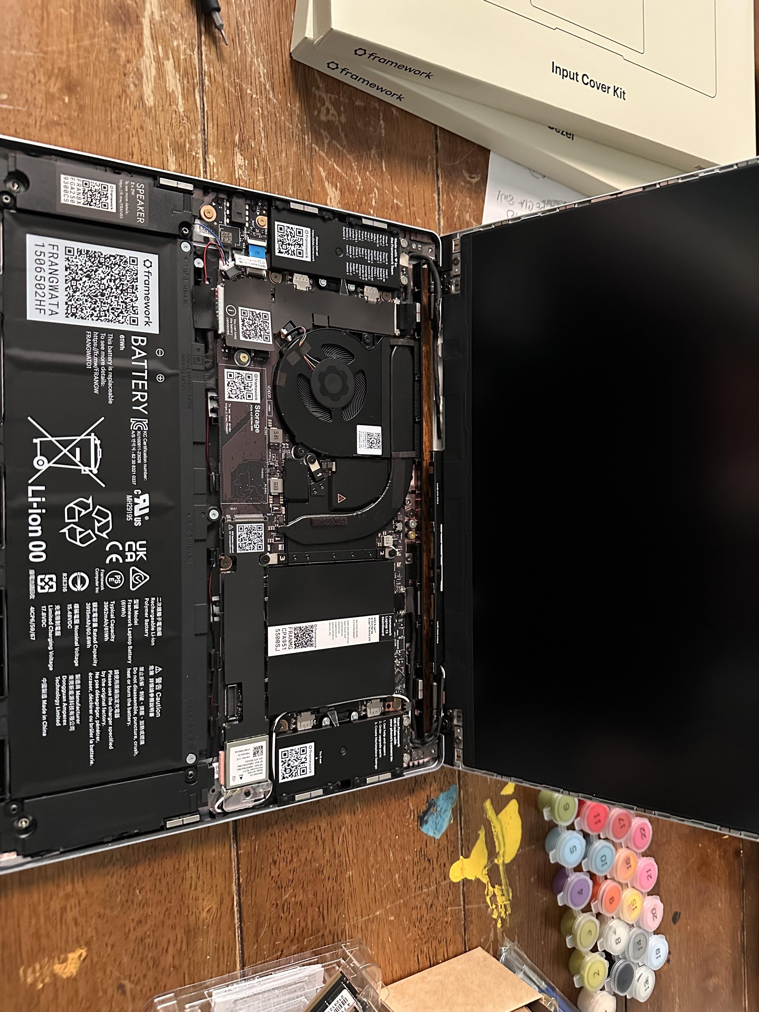 A framework 13 without the input cover on so you can see all of its guts. There’s a batter at the bottom, the spot for the drive is above it, then the fan and memory slots are next to each other above that. It’s all very well organized. 